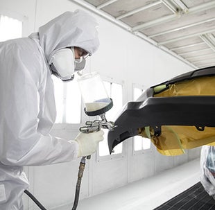Collision Center Technician Painting a Vehicle | Bommarito Toyota in Hazelwood MO